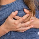 Woman having chest pain, heart attack